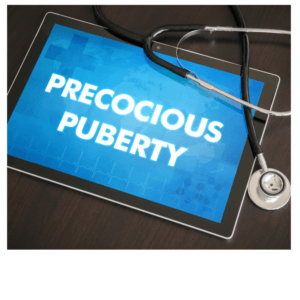 alt = "Precocious Puberty written on a tablet with the doctors stethoscope by the side"