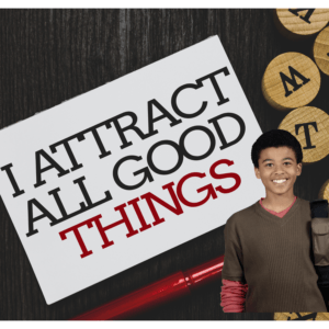 " A smiling teen boy with a boldly written affirmation ' I Attract all Good Things'"