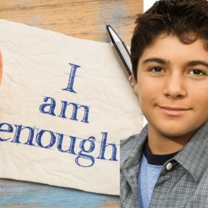 "A partially smiling teen boy with an affirmation poster next to him written, I am enough"